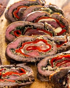 sliced meatloaf with red peppers and cheese on a cutting board