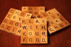 scrabble tiles spelling words that spell out food on a wooden table with other scrabbles