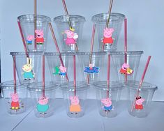 there are many plastic cups with peppa pig stickers on them and straws sticking out of them