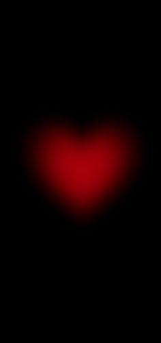 a heart shaped object in the dark with red light coming from it's center