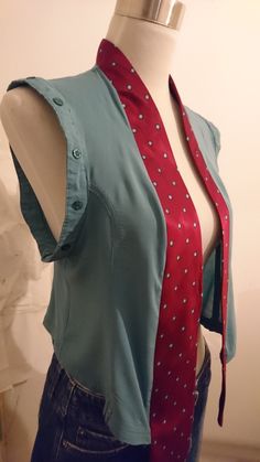 a mannequin wearing a blue shirt with red and white polka dots on it