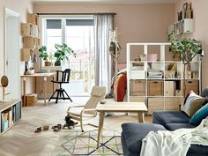 a living room filled with furniture and lots of bookshelves next to a window