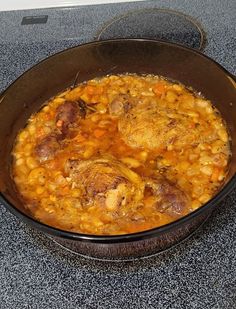 a pot filled with food sitting on top of a stove