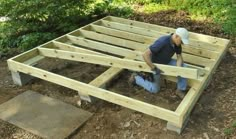 a man working on building a wooden structure