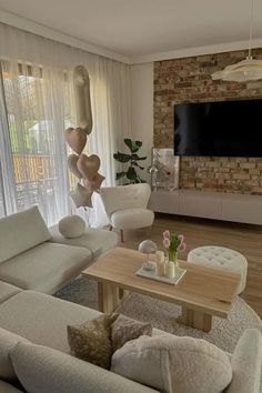 a living room filled with furniture and a flat screen tv mounted to the wall over a fireplace