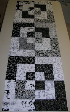 a close up of a table top with black and white quilts on it's surface