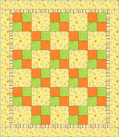 an orange, green and yellow quilt with squares on it's edges in the center