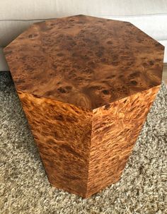 a wooden table sitting on top of a carpeted floor