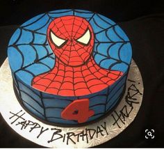 a birthday cake with a spiderman design on it's face and the number four