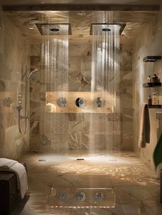 a bathroom with a large shower head and two hand held shower heads on the wall