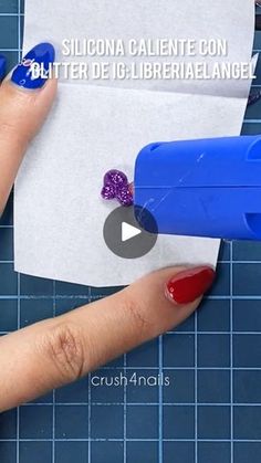 someone cutting out some paper with scissors on top of it and another piece of paper in the background