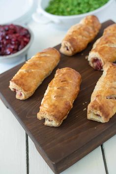 several cranberry turnovers on a cutting board