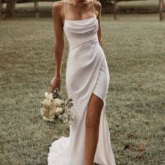 a woman in a white dress holding a bouquet