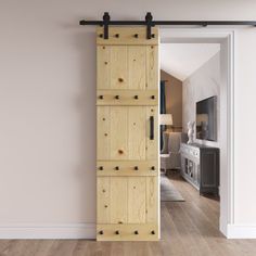 an open sliding door in a living room with wood flooring and white wall paint