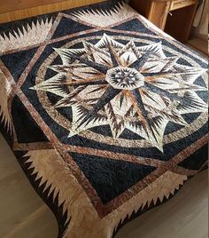 a quilted bedspread with an intricate design on the top and bottom edge