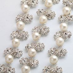 This beautiful trim is made of high-quality clear rhinestones. It is perfect for all special occasions. It can be used for wedding dress, wedding belts and sashes, bridesmaid sashes and belts hats, headbands, headpieces, flower bouquet wrap, wedding invitation, gowns, hair accessory, sash craft, jewelry, cake decoration, bags, scrapbook or any other decorations. Applying Method: Sew on, Glue on Color: silver Gold Size: Width: 3/4 Inches Length: 1 Yard Please contact us for wholesale quantities a Elegant Silver Embellished Bridal Belt, Embellished Crystal Bridal Belt In Silver, Sparkling White Rhinestone Necklace For Wedding, Silver Crystal Bridal Belt For Wedding, Elegant Embellished Crystal Bridal Belt, Crystal Bling Backdrop Necklace For Wedding, Silver Bling Backdrop Necklace For Weddings, Silver Rhinestone Bridal Belt For Prom, Silver Rhinestone Bridal Belt For Formal Occasions