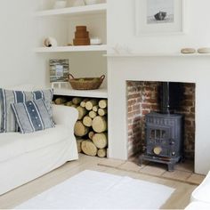 a living room filled with furniture and a fire place next to a white couches