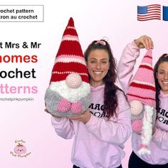 two women in pink sweaters holding knitted gnome hats