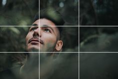 a man looking up at the sky with trees in the background