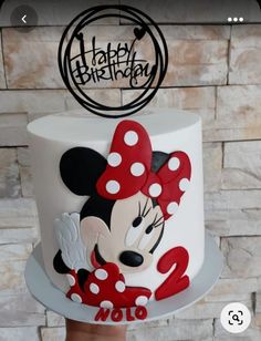 a birthday cake with a minnie mouse on top