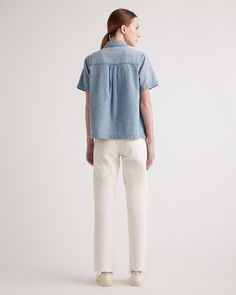 When easy does it, you need this Distressed Denim Short Sleeve Shirt. A total classic, it features a full button front, chest pockets, and a subtly distressed wash. The boxy fit feels like a modern update and looks amazing over figure-skimming skirts and pants.  | Quince | Women's Distressed Denim Short Sleeve Shirt in Blue, Size XS, Cotton Denim Short Sleeve Shirt, Chambray Shorts, Denim Short, Distressed Denim Shorts, Navy Pants, Black Charcoal, Quince, Smart Casual, Distressed Denim