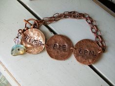 "❤️ Genuine copper pennies are smashed and smushed into beautiful and unique copper medallions. Antiqued copper chain holds the personalized medallions with names of the loved ones. A czech heart and flower bead dangles. Extra medallions can be added for $10 each. Total chain length 7.5 inches. Please measure your wrist with a string and let me know what length you would like or I will send it as 7.5 inches. Each Medallion measures 1\" x 1\". This bracelet can be made into a necklace and be cust Copper Pennies, Bead Dangles, Metal Stamped Jewelry, Silverware Jewelry, Lucky In Love, Viking Jewelry, Copper Chain, Copper Bracelet, Stamped Jewelry