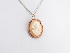 This lovely pendant is crafted in wonderful tones of peach and pink with accents of creamy white! Polished 14 karat rose gold comprises the frame, while the cameo at the center is carved from a traditional conch shell. This pendant does not come with the chain shown. Please feel free to contact us, we will help you find the perfect chain for your style and budget! Metal: 14K Rose Gold Gem: Shell Cameo Gem Measurements: 19.7 x 14.5 mm, Oval Measures: 21 x 33 mm, with bail Marks: "14K" Stamped on the reverse Rose Gold Cameo Jewelry Gift, Rose Gold Cameo Jewelry For Gifts, Antique Rose Gold Cameo Jewelry, Heirloom Cameo Pendant Necklace, Heirloom Cameo Pendant Jewelry, Elegant Rose Gold Cameo Necklace, Pocket Watch Chain, Cameo Pendant, Conch Shell