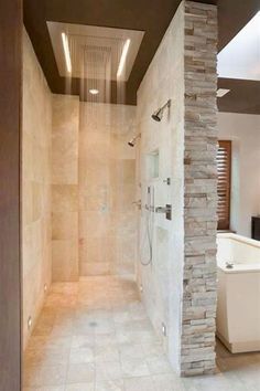 a walk in shower sitting inside of a bathroom