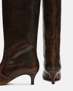 Upgrade your boot game with the LANDER boots. These boots have a square toe, knee-high length, and a trendy kitten heel and elevate any outfit while providing comfort and support. Perfect for everyday wear or dressing up for a night out. 2 inch heel height 14.75 inch shaft circumference 15.25 inch shaft height Leather Kitten Heel Boots, Brown Knee High Boots, Heel Boot, Fall Winter Wardrobe, Window Shopping, Swag Shoes, 2 Inch Heels, Kitten Heel, Boss Lady