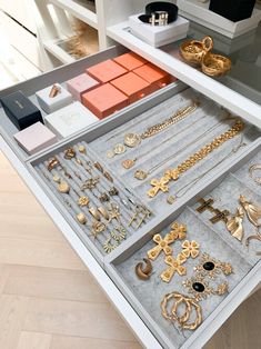 an open drawer filled with lots of gold jewelry