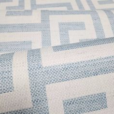 a blue and white patterned fabric with squares on it's sides, as well as an interwoven pattern