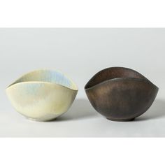 two bowls sitting next to each other on a white surface