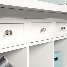 a white cabinet with drawers and knobs on it