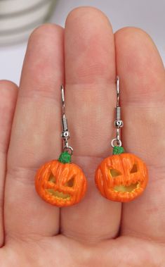 🚀!Important - Christmas orders: If you want to make sure that your package will get to you before Christmas, please choose - DHL Express shipping - upgrade (2-4 day shipping time) at the checkout! Standard postal shipping from Hungary can take 15 business days with delays during the Holiday season! This Jack O Lantern Dangle Earrings will definitely make a statement! Create a bomb look with this funny earrings! It is the perfect unique earrings for the Halloween, or a gift to somebody who loves to wear one of a kind, creative accessories. D E T A I L S: * Handmade Pumpkin Dangle Earrings * Made from Polymer Clay * Width: 0.7 inches (2 cm) * Earring posts: Stainless steel * Earrings are light and easy to wear * Earrings will arrive in a nicely packed eco friendly box 😉 Get -15% OFF from y Polymer Clay Jack O Lantern, Novelty Orange Earrings For Halloween, Spooky Handmade Earrings For Halloween, Handmade Spooky Halloween Earrings, Spooky Handmade Halloween Earrings, Handmade Witchy Earrings For Halloween, Spooky Pierced Earrings For Halloween, Handmade Halloween Costume Earrings, Halloween Novelty Drop Earrings Jewelry