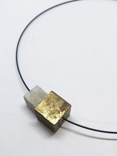 minimalist modern necklace in black stainless steel with 2 cubes of concrete. An element was processed with gold paint. All pieces of jewelery are designed and cast in our studio in the south of Hesse. The extra fine concrete is especially suitable for exclusive pieces of jewelry. The concrete pieces are processed in their natural state (unhoned and polished). Each chain is thus individual and unmistakable. Handmade in the style of CA.ON.IS. BAGS Choker circumference 40cm Lock for turning design & made in germany Minimalist Square Pendant For Jewelry Making, Minimalist Adjustable Square Pendant Necklace, Minimalist Brass Square Pendant Jewelry, Minimalist Brass Necklace With Square Pendant, Concrete Minimalist, Gold Concrete, Choker Chain Necklace, Concrete Jewelry, Modern Necklace