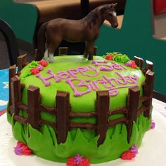 a green birthday cake with a horse on top