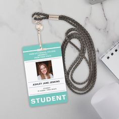 an id badge with a lanyard attached to it next to a computer mouse and keyboard