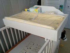 a baby crib that has some items on it