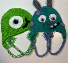 two crocheted hats with eyes and ears