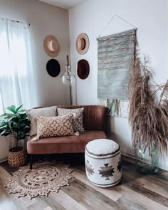 a living room filled with lots of furniture and decor on top of a wooden floor