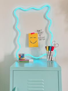 a blue cabinet with a neon light on it and a note attached to the wall