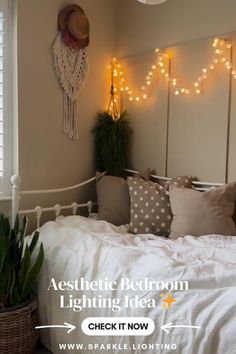 a bedroom with lights on the wall and a bed in front of a basket full of plants