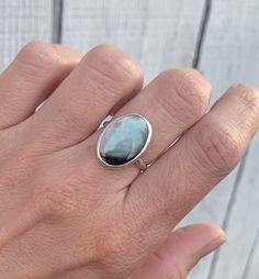 Luminescent Vertical Black or White Mother of Pearl Oval Sterling Silver Ring | Mermaid Jewelry | Boho | Shell Ring | June Birthstone by GildedBug on Etsy Elegant Iridescent Cabochon Ring, Black Oval Opal Jewelry, Elegant Iridescent Opal Ring With Cabochon, Iridescent Opal Ring Oval Shaped, Oval Black Opal Jewelry, Elegant Iridescent Cabochon Opal Ring, Iridescent Oval Opal Gemstone Ring, Unique Oval Iridescent Jewelry, Iridescent Cabochon Ring As Gift