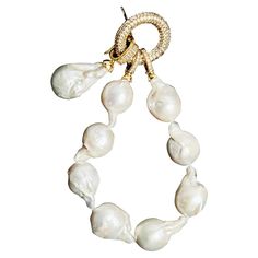 Pearl bracelet with genuine baroque pearls with an adorned lock shining with crystals and a removable oversized genuine baroque pearl charm. Luxury Adjustable Bracelet With Baroque Pearl, Luxury Jewelry With Baroque Pearl Charm, Elegant Baroque Pearl Bracelet, Elegant Baroque Pearl Bracelet With Pearl Charm, Bracelet With Pendant, Black Pearl Bracelet, Luxury Baroque Pearl Charm Bracelet, Modern Bracelets, Pearl Charms