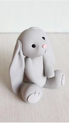 a small white toy sitting on top of a table