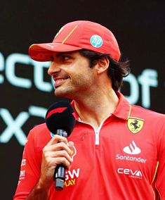 a man wearing a red hat and holding a microphone