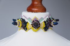 Colorful raw titanium choker necklace. Alternative wearable art jewelry gift for fashion lovers. Choker is adjustable on the back with volume of each neck. MADE TO ORDER - shades may differ slightly. Materials: Natural purple Titanium Crystal Agate. Purple glass crystals beads. Yellow glass beads. Pale purple seed beads. Pale green seed beads. Pale yellow seed beads. Neutral seed beads. Yellow seed beads. Purple seed beads. Vegan leather. Sterling silver claps. FREE SHIPPING. We offer fast shipp Unique Adjustable Choker With Unique Variations, Unique Adjustable Choker With Variations, Artistic Adjustable Choker Jewelry, Titanium Crystal, Mermaid Shell, Beadwork Designs, Wearable Art Jewelry, Crystals Beads, Pale Purple