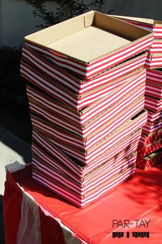 several boxes stacked on top of each other with red and white striped paper covering them