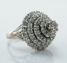 an antique diamond cluster ring on a white background