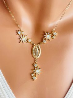 This is a stunning 14K gold filled Mary miraculous necklace with blue  or white opals. This gorgeous necklace is even more impressive in person. Miraculous medal measures 23X13 mm and has MARY stamp on back. These are lab created  opals with CZ and Pave crystals. Necklace on model is a 15 inch in length. The length is the measurement around the neck only it does not include the drop.  Drop is approximately 2 inches. Necklace is completely 14K gold filled with a spring clasp in back. Please measure your neck and choose your desired length in the drop-down list. I also feature this necklace with blue opals in the last few photos. Please choose whether you want white or blue opal.  This gorgeous necklace will come in a beautiful gift box ready to present. This necklace is exquisite, a gift. S White Miraculous Medal Necklace For Wedding, Elegant White Miraculous Medal Jewelry, Elegant Miraculous Medal Necklace For Gift, Celestial White Opal Jewelry, Gold Miraculous Medal Necklace Gift, Elegant Miraculous Medal Necklace, White Pendant Jewelry With Miraculous Medal, White Miraculous Medal Spiritual Jewelry, Catholic Jewelry Necklace